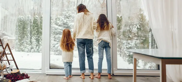 Kids and mom looking keeping warm inside